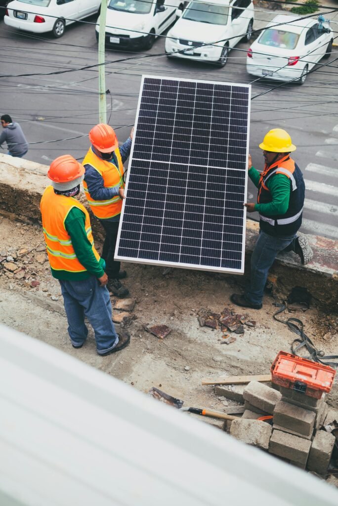 pexels photo 8853501 8853501 Workers in safety gear installing a solar panel outdoors.